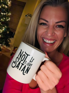 woman holding a Christmas mug