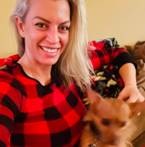 woman holding her dog smiling